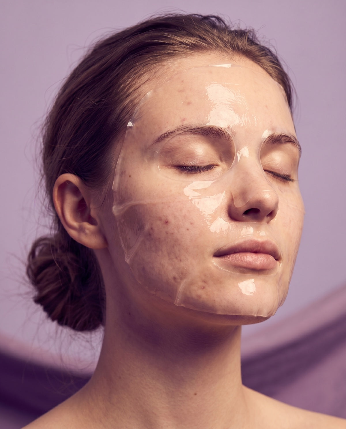 Young woman wearing a Serica PDRN Collagen Mask, eyes closed, calm expression